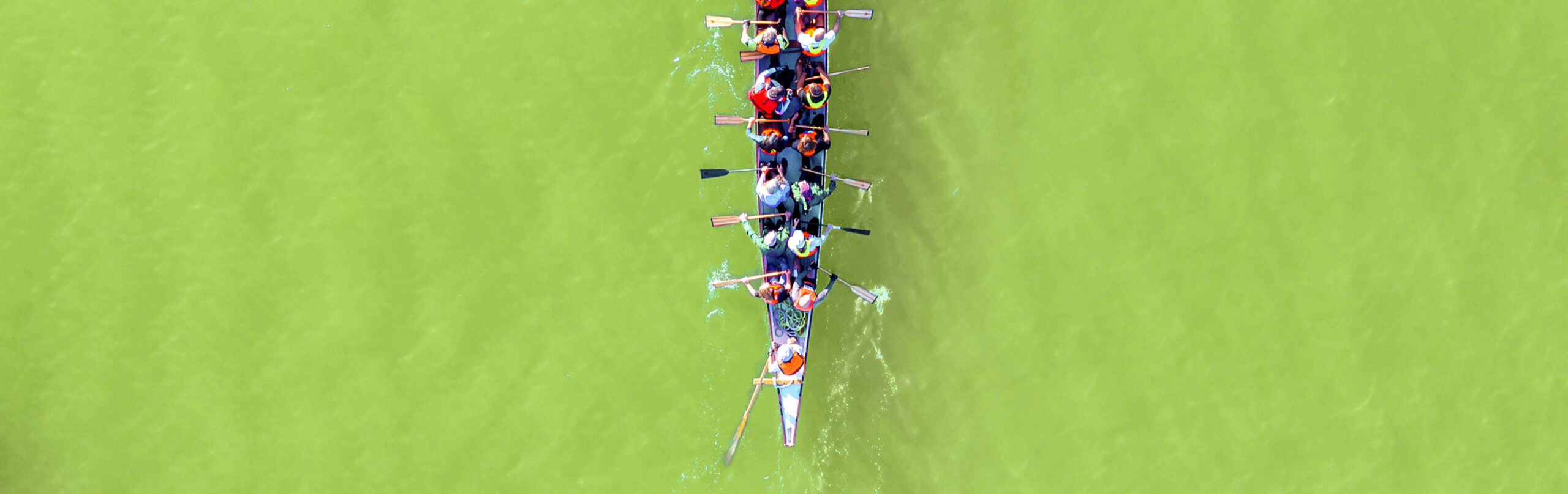 Haifa, Israel - December 11, 2020: Dragon Boat team rowing to the pace of an onboard Drummer, Aerial view.